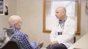 Kevin Bass DMD with a patient.